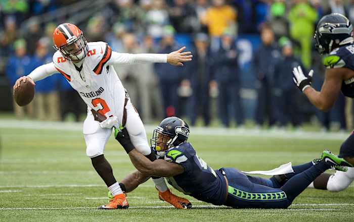 Cleveland Browns quarterback Johnny Manziel (2) get away a pass as he is tackled Seattle Seahawks linebacker Bruce Irvin (51) during a game at CenturyLink Field.